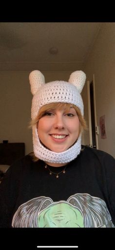 a woman wearing a white knitted hat with ears