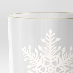 a white vase with snowflakes on it