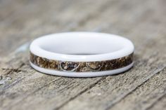 two wedding bands are sitting on a wooden surface