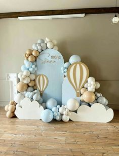 a balloon arch with balloons and hot air balloons