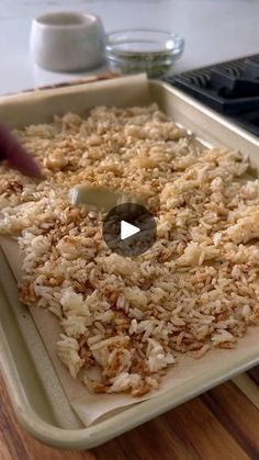 a pan filled with food sitting on top of a wooden table