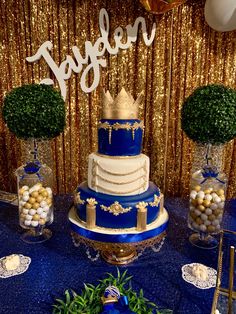 a blue and gold wedding cake on a table