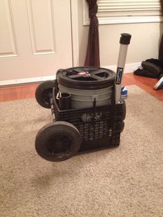 a black cart sitting on top of a floor next to a white door in a living room