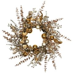 a christmas wreath with ornaments hanging from it's sides and greenery around the edges