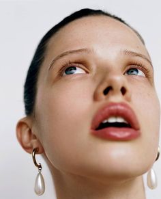 a woman with her eyes closed looking up