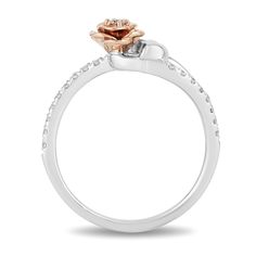 a white gold engagement ring with an orange flower on the center and diamonds around the band