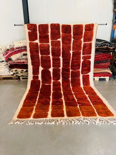 a red and white area rug in a warehouse