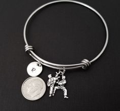 "Personalized Antique Silver Karate Bangle Bracelet! A karate charm on an expandable bangle bracelet makes the perfect gift for your favorite karate student. The martial arts bracelet charm is made from zinc alloy and measures 12 mm by 23 mm. The taekwondo bangle bracelet is high quality stainless steel and fits a wrist sized 6-8\". The sports bangle bracelet is personalized with a .5\" silver plated disc stamped with the initial of your choice. The charm and initial disc are connected to the ba Bible Verse Bracelet, Boys Bracelets, Prayer Bracelet, Bracelet Initial, Expandable Bangle Bracelet, Moms Bracelet, Split Rings, Initial Bracelet, Charm Bangle