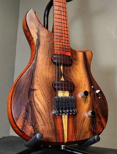 a wooden guitar sitting on top of a table