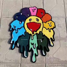 a group of colorful painted hands sitting on top of a tile floor next to a sidewalk