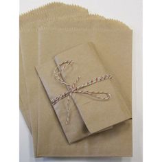 four brown paper bags tied with twine