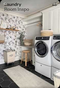 a washer and dryer in a room with wallpaper on the walls behind them