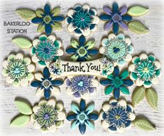 decorated cookies with the words thank you written on them in blue, green and white