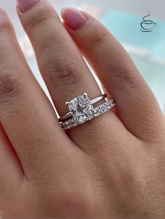 a woman's hand with a diamond ring on it