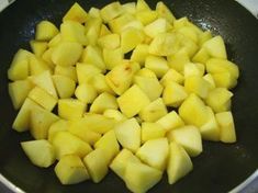 cut up potatoes in a frying pan on the stove top, ready to be cooked