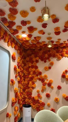 a room with flowers on the ceiling and chairs