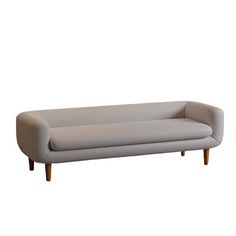 a gray couch sitting on top of a white floor next to a wooden leg chair