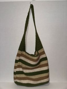 a green and white purse hanging on a wall