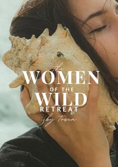 a woman holding a large piece of wood with the words women of the wild in front of her face