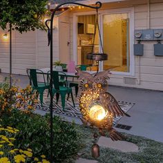 an owl lamp sitting on top of a metal pole