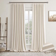 a living room with white walls and curtains on the window sill, carpeted floor