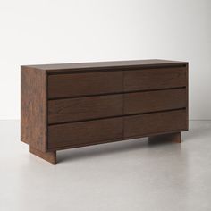 a wooden dresser sitting on top of a white floor