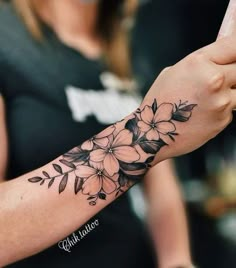 a woman with a flower tattoo on her arm