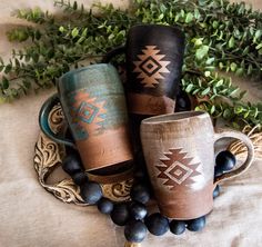 three coffee cups sitting on top of a table