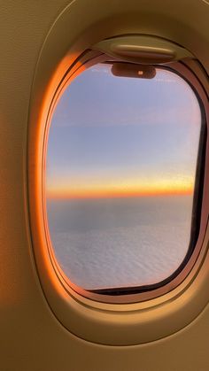 an airplane window looking out at the ocean