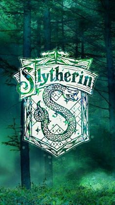 slytherin logo in the middle of a forest