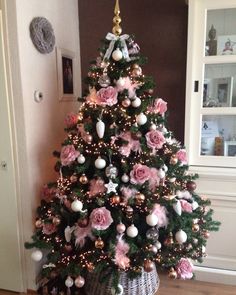 a decorated christmas tree with pink and white ornaments