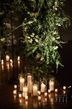 many lit candles are sitting on the table