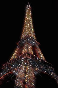 the eiffel tower lit up at night with lights on it's sides