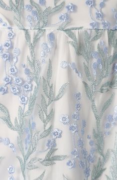 the back of a dress with blue flowers on it