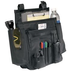 the back pocket of a black bag with pens, pencils and other items in it