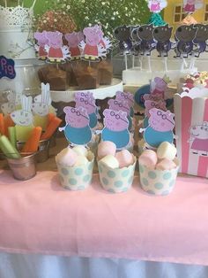 peppa pig cupcakes and other treats on a table