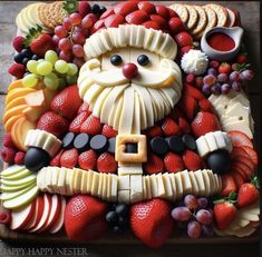 a platter filled with fruit and cheese shaped like santa clause