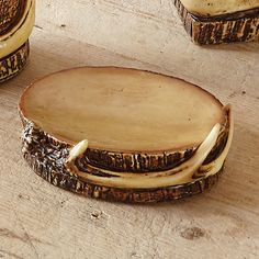 three pieces of wood sitting on top of a wooden table