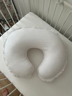 a white pillow sitting on top of a baby crib