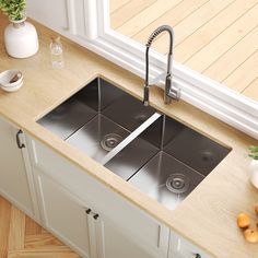 a kitchen sink with two faucets in it