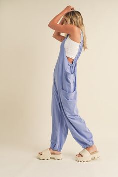 Upgrade your loungewear game with our Soft & Comfy Onesie Jumpsuit. The relaxed fit and dropped crotch provide ultimate comfort while the oversized pockets and adjustable waistline add functionality. Perfect for layering, this slouchy style with a racerback silhouette will become your go-to outfit for all-day comfort. Jumpsuit Comfy, Slouchy Jumpsuit, Colorful Romper, Oversized Pockets, Comfy Jumpsuits, Cute Pajama Sets, Blue Jumpsuit, Denim Jacket With Dress, Slouchy Style