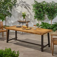 a wooden table sitting next to two chairs