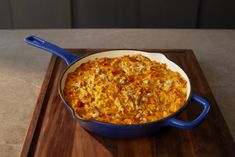 a casserole dish is sitting on a cutting board