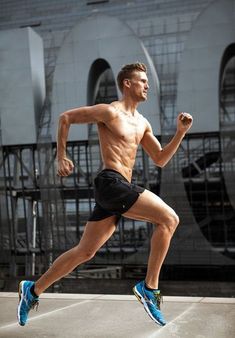 a shirtless man running on the street