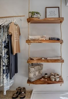 a shelf with shoes and other items on it next to a wall mounted clothes rack