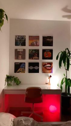 a room with pictures on the wall and a red light in front of it that reads work in progress