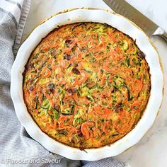 a casserole dish with carrots and zucchini