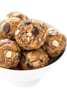 a white bowl filled with chocolate chip cookies and oatmeal bites on top of each other