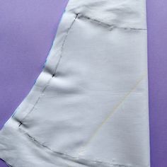 a piece of white fabric with yellow stitching on it