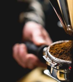 a coffee grinder filled with ground coffee